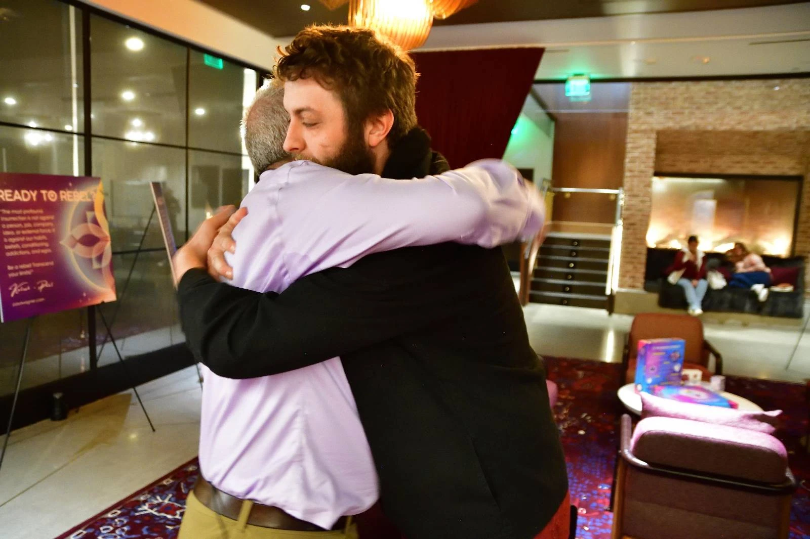 Paul embracing a male participant at a previous workshop